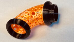 Build Super Flow Tubes into a groovy LED marble run sculpture you can display, play and dance with! Orange Curve detail. Patent Pending # 19/203,500.