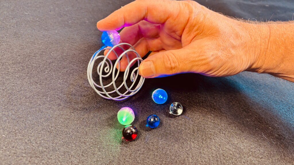 Zorbit Sphere by Super Flow Yo is a groovy hand-held spiral cage for spinning marbles, comes with 3 glass and 3 LED marbles.